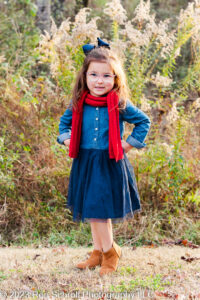 Young girl posing for individual photo during fall family photos with Ron Schroll Photography at Bridge to Antiquity in Davidson, NC
